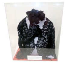 A black lace jacket, with hat, in perspex glazed case, 52cm wide.
