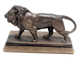 After Barye. Regal Lion, bronzed resin replica, depicting a lion on a rectangular plinth, 40cm wide,