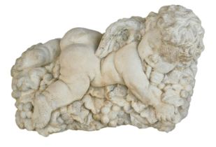 A reconstituted stone Bacchus figure, lying on a bed of grapes, 27cm wide.