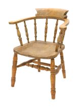 A 19thC ash and elm captain's type chair, with spindle turned supports, solid seat, on turned legs.