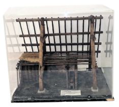 A diorama model of a small Viking/Saxon dwelling, showing structure, in perspex case, 36cm wide.