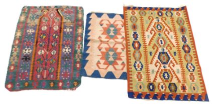 Three Eastern Kilim rugs, each with a multicoloured geometric design, 156cm x 117cm, 138cm x 106cm a