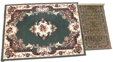 A Belgian cotton machine woven rug, decorated with scrolls, flowers, etc., on a green ground, and a