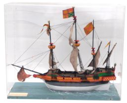 A model of an Elizabethan galleon, polychrome painted with naturalistic base and Perspex and wooden