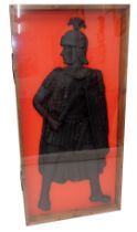 A replica ebonised plaque, modelled in the form of a Roman soldier, in perspex glazed case, 122cm hi