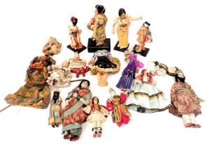 A quantity of mainly Eastern costume dolls, to include Japanese dolls, musical doll with ceramic hea