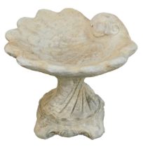 A reconstituted stone shell capped birdbath, with large shell moulded top, on a square shell stem, 3