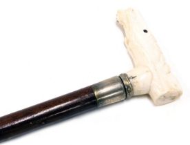 A 20thC hand carved bone handled walking cane, formed as a horse's head, 87cm high.