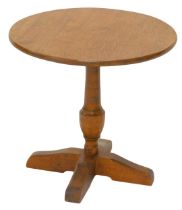 An oak wine or coffee table, in Arts & Crafts style, the circular top turned column and egg shaped b