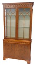 A George III style yew wood display cabinet, with dentil moulded cornice, astragal glazed doors over