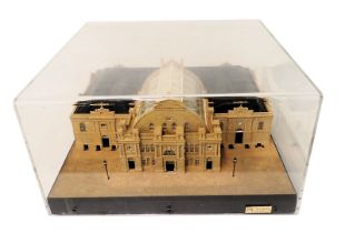 A scale model of a Georgian building with glazed roof, decorative portico, clock, circular arched wi