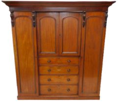 An early Victorian figured mahogany inverted breakfront wardrobe, with a moulded cornice above an ar