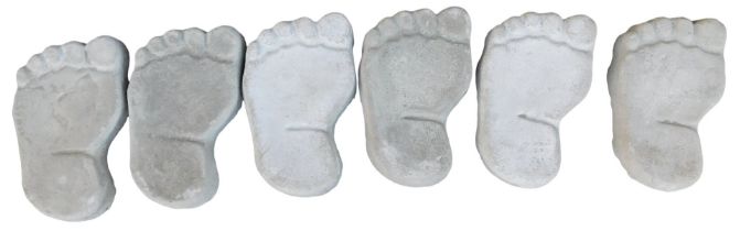 A set of six reconstituted stone foot stepping stones, each 25cm high.