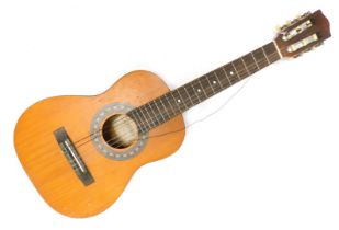 An Encore child's acoustic guitar, 85cm high.