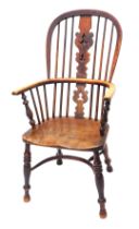 A 19thC ash and elm Windsor chair, with a pierced splat, solid seat on turned legs with crinoline st