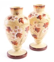 A pair of Victorian milk glass vases, with brown mottled border and foot, with leaves and cherry blo