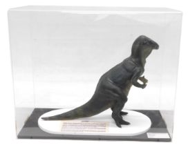A museum model of an Iguanodon dinosaur, in fitted perspex case, 62cm wide.