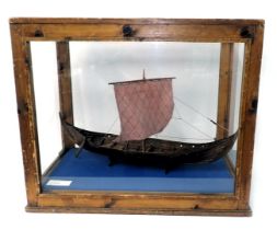 A scale model of a Viking longboat, in stained pine and perspex case, 67cm wide.