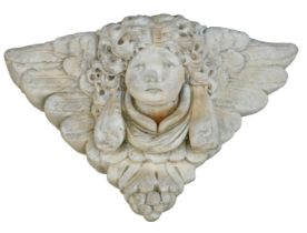 A reconstituted stone cherub's face wall mounted plaque, 36cm wide.