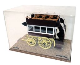 A model of an early 20thC horse omnibus or carriage, in orange, maroon, white and yellow livery, wit