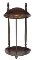 A mahogany walking stick stand, with turned finials vacant brass cartouche, of demi lune form, 93cm