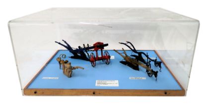 A collection of scale models of ploughs, two polychrome decorated, the others in pine, dates ranging