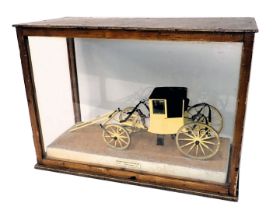 A scale model of a Post Chaise Carriage, circa 1740, in a black and yellow livery, with marooned doo