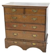 A late 18/early 19thC oak chest on stand, with two short and three long drawers, each with brass dro