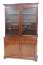 A late Victorian mahogany cabinet bookcase, with moulded cornice, two glazed doors over a base with