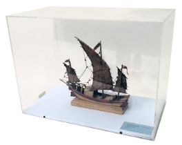 A scale model of Chinese junk, with three sails, polychrome decoration, in perspex case, 54cm wide.