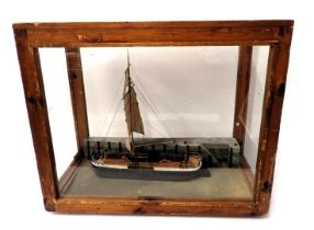 A scale model of a single masted barge, polychrome decorated with realistic base, in stained pine an