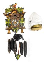 A German cuckoo clock, oak design with moulded and painted leaves, 20cm high, and a pressed and moul