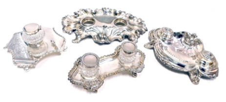 Four Victorian and later silver plated inkwells, one lacking bottle, 27cm, 20cm and 24cm diameter.