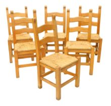 A set of six pale beech ladder back dining chairs, each with a rush seat.