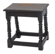 An ebonised oak joint stool, rectangular top with a moulded edge, on turned supports, 44cm high, 45c