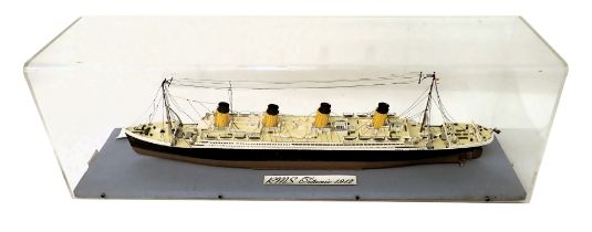 A scale model of the R.M.S Titanic, circa 1912, with four masts, polychrome decorated, in perspex ca