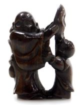 A contemporary Japanese style hardwood netsuke, carved as a father and son holding a noh mask, 4.5c