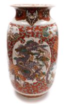 A Japanese Meiji period pottery vase, of cylindrical form with a flared rim, decorated with a reserv