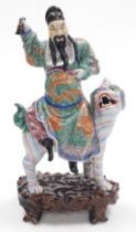 A 19thC Qing dynasty famille verte porcelain figure group, modelled as the Immortal Fuxing seated up