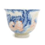A Qing dynasty blue and underglaze red decorated cup, with partial craquelure glaze, the three boys