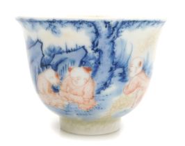 A Qing dynasty blue and underglaze red decorated cup, with partial craquelure glaze, the three boys