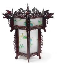 A 20thC Chinese hardwood lantern, of hexagonal form, inset with glass panels, painted with watercolo