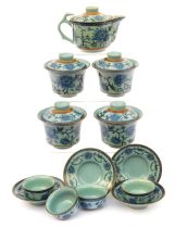 A modern Chinese pottery part tea service, decorated in blue and white with peonies against a pale b