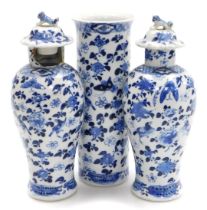 A garniture of Kangxi style porcelain blue and white vases, decorated with birds, flowers and butter