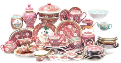 A Chinese red ground Mun Shou longevity dinner and tea service, including plates and bowls, teapots,