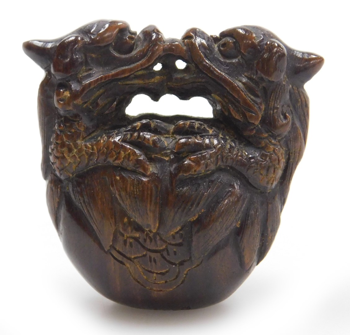 A contemporary Japanese style hardwood netsuke, carved as two dragons embraced over a bell signed, 4