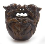 A contemporary Japanese style hardwood netsuke, carved as two dragons embraced over a bell signed, 4