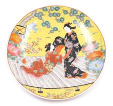 A Japanese porcelain charger, decorated with geisha on a platform, within a garden, impressed seal m