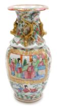 A 19thC Qing dynasty Cantonese famille rose porcelain vase, of baluster form, moulded to the shoulde