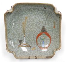 An early 20thC Chinese ge-type dish, of curved, square form, over painted with a vase of peacock fea